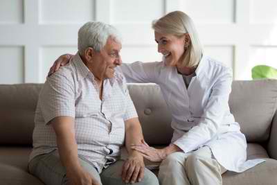 senior man and caregiver talking