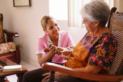 senior woman and female caregiver talking